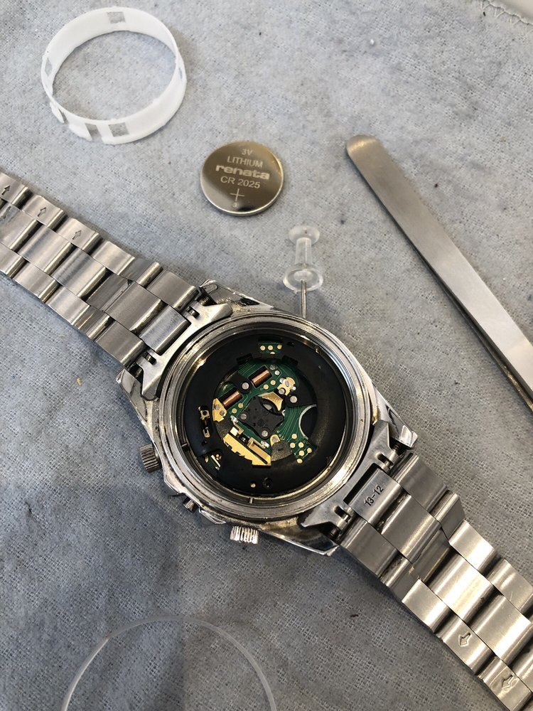 silver watch being disassembled