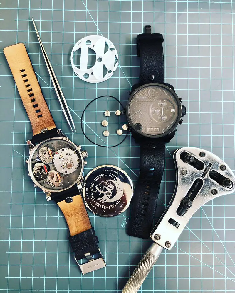 disassembled watches with black leather bands